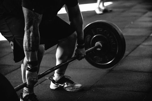 man doing squats with weights