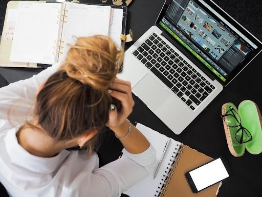 a stressed out woman at computer