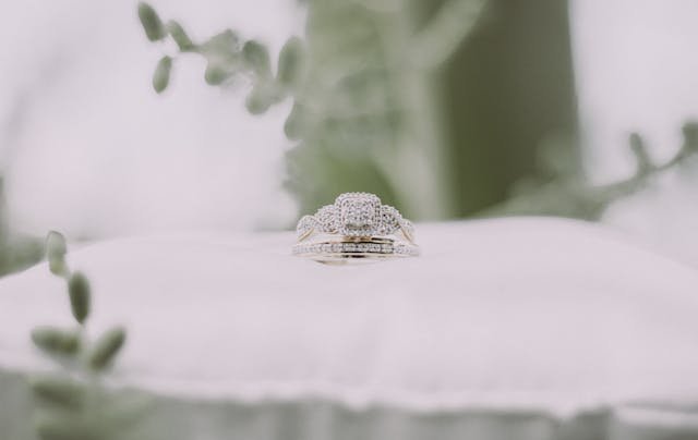 Elegant wedding ring displayed on a white pillow.