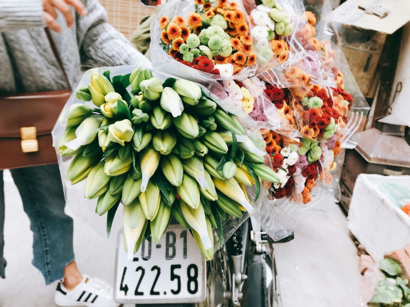 a few bouquets of flowers being held.