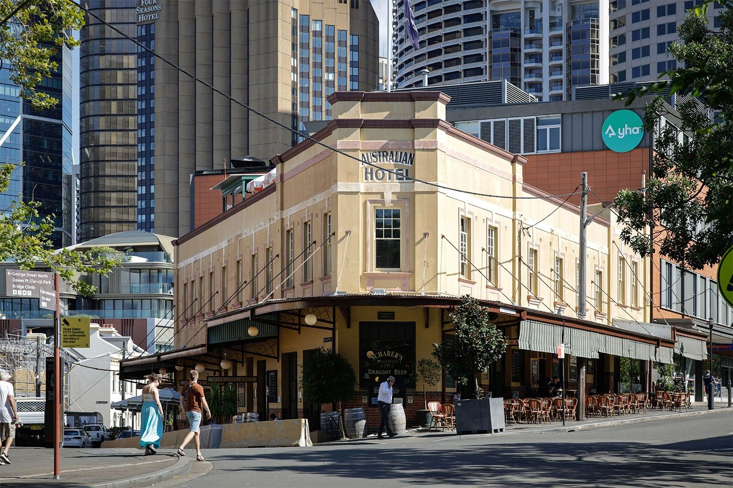 The historic Australian Hotel at The Rocks, featuring its cream-coloured heritage facade, corner entrance and traditional pub frontage against Sydney&rsquo;s modern city buildings.